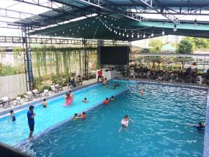 a group of people in a swimming pool at Motel Happy House- Hảo in Bạc Liêu