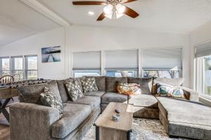 a living room with a couch and a ceiling fan at Waterfront Trinity Vacation Rental with Hot Tub! in Riverside