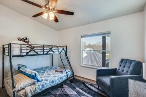 a bedroom with a bunk bed and a chair and a ceiling fan at Waterfront Trinity Vacation Rental with Hot Tub! in Riverside