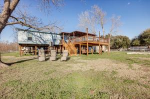 a large house with a porch and a deck at Waterfront Trinity Vacation Rental with Hot Tub! in Riverside