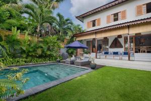 une cour arrière avec une piscine et une maison dans l'établissement Villa Maya Scenic in Canggu, à Dalung