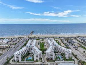 an aerial view of a resort near the ocean at Beautiful newly renovated beachfront condo at Casa Del Mars in Galveston