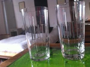 two empty glasses sitting on a green table at Au détour Du Larrech in Castillon-en-Couserans