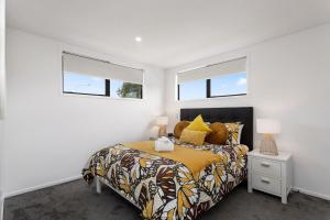 a bedroom with a bed and two windows at Luxury Style Free Street Parking CBD Location in Christchurch