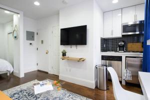 a kitchen with white cabinets and a table in a room at 69-3B Prime Lower East Side BRAND NEW 1br Apt in New York