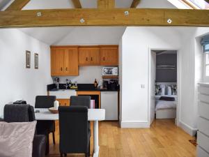 a kitchen and dining room with a table and chairs at Uk46354 - Old Chimneys Cottage in Wivelsfield Green