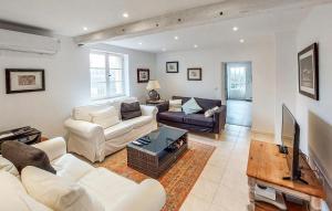 a living room with white furniture and a tv at Pet Friendly Home In Armillac With House A Panoramic View in Armillac