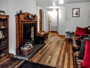 a living room with a couch and a fireplace at Grange Court in Cliburn