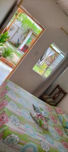 a bedroom with two windows and a bed in a room at HOSTAL SARITA in Villavieja