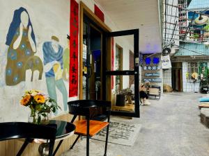 a room with two chairs and a mirror in a store at Guilin Cyan Box Guest House in Guilin