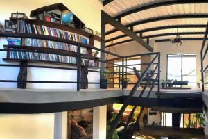 uma escada em espiral numa sala de estar com estantes de livros em Casa de Campo Natural y Tranquila 