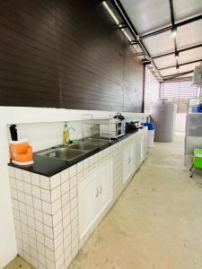 - une cuisine avec un évier dans la chambre dans l'établissement Patteera Pool Villa Sattahip, à Sattahip