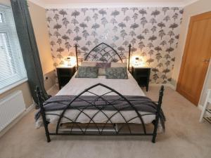 a bedroom with a large bed with two night stands at Garden View in Pembroke