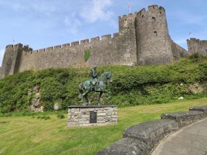 a statue of a man on a horse in front of a castle at Garden View in Pembroke