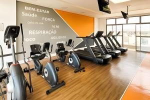 a gym with treadmills and elliptical machines at Nosso Apê 915: Central | Academia | Piscina NA0714 in Juiz de Fora