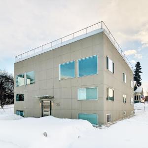 a building with blue windows in the snow at Snob Hollow Inn Downtown Anchorage in Anchorage