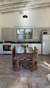 a kitchen with a table and chairs in a room at 12 Olivos Cabañas in San Rafael