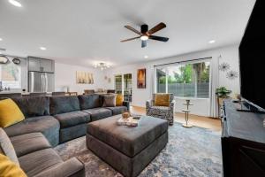 a living room with a couch and a ceiling fan at Gorgeous 4BR/2BA Home in North Central Phoenix in Phoenix