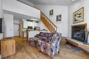 a living room with a couch and a fireplace at Sierra Cabin Condo – Sun Meadows 1 BedroomLoft condo in Kirkwood