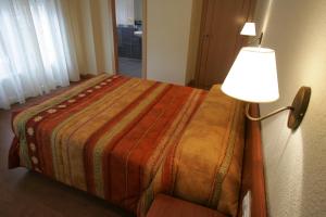 Cama o camas de una habitación en Hostal Hispanico II