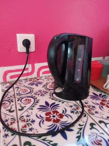 a black toaster sitting on top of a table at CHEZ ALIZHIA in Nuku Hiva