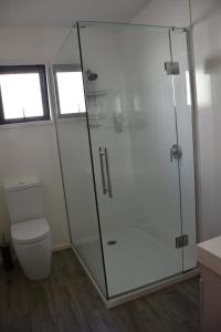 a bathroom with a shower and a toilet at Roxburgh Motels in Roxburgh