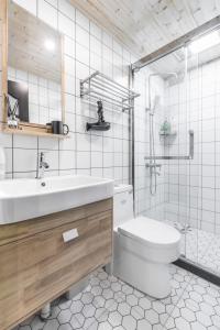 a white bathroom with a sink and a toilet at Shanghai Hills & Xing 6136 Homestay Mid Huaihai Rd Near Metro Line10 Xintiandi in Shanghai