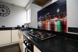 Spacious | 3BR | WiFi في نيوبورت: مطبخ مع موقد مع صورة للمدينة