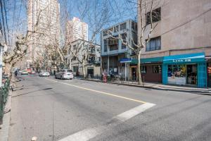 an empty street in a city with buildings at Shanghai Hills & XING 48 Homestay West Fuxing Rd Near Metro Line1 and Line7 Changshu Rd Station in Shanghai