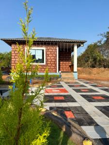 a house with a stone pathway in front of it at Yashovana Nature Stay Gokarna in Gokarna