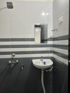 La salle de bains est pourvue d'un lavabo et d'un miroir. dans l'établissement Yashovana Nature Stay Gokarna, à Gokarna