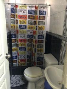 a bathroom with a toilet and a bunch of beer cans at condominio la muralla in Lima