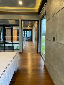 a bedroom with a bed and sliding glass doors at Villa AZJA PD in Port Dickson