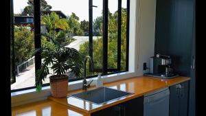 a kitchen counter with a sink and a window at Paihia Lighthouse in Paihia