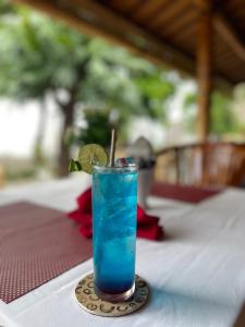 a blue drink sitting on top of a table at New Starlight Hotel Lovina in Lovina