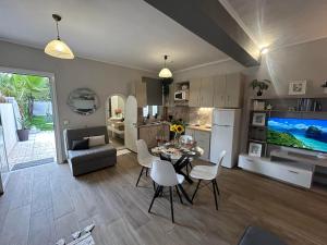 a kitchen and living room with a table and chairs at Karydakis Properties in Zakynthos Town