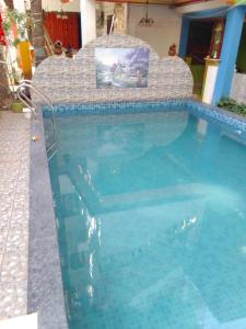 a swimming pool in a house with a swimming pool at Hotel Sea side in Calangute