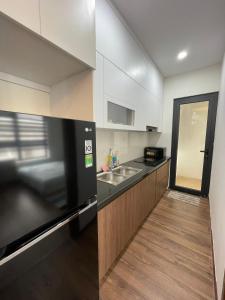 a kitchen with a sink and a counter top at Mami House - Luxcity Cẩm Phả Serviced Apartments in Cẩm Phả