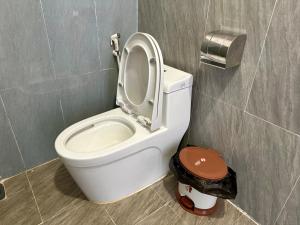 a toilet with the seat up in a bathroom at Người Măng Đen Homestay in Kon Von Kla