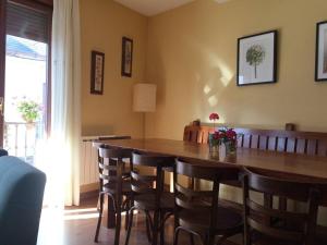 a dining room with a wooden table and chairs at 5 bedrooms house with wifi at Molinaseca in Molinaseca