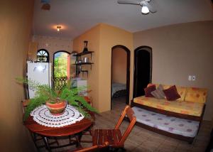 a living room with a table and a couch at Sumiko Chalés in Ubatuba