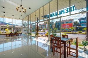 a shopping mall with a table and chairs in the lobby at The Palm Krabi Residence And Resort in Ban Khlong Chi Lat