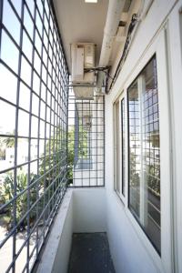 an empty corridor in a building with windows at THE EKAH COMFORTS in Bangalore
