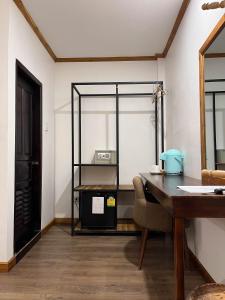 an office with a desk and a shelf in a room at Luang Prabang Villa Oasis in Luang Prabang