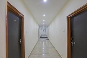 an empty hallway with two doors and a hallwayngth at OYO Flagship J.d.p Guest House in Varanasi