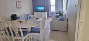 a dining room with a white table and chairs at Seaview Property 3B Two Bedroom Apt Hasting Towers in Bridgetown