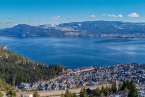a view of a large body of water with houses at Hilltop Haven at La Casa Resort Lakeside Kelowna in Kelowna