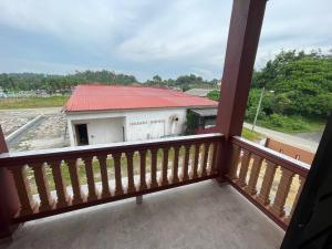 a balcony view of a building with a red roof at Homestay ZR in Kuala Berang