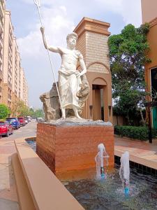 a statue of a woman with a spear in a fountain at Atlantis Condo Resort in Jomtien Beach