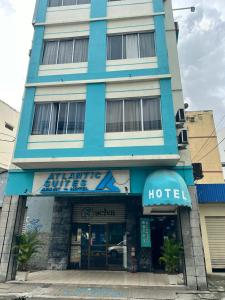 a large blue building with a hotel at Atlantic Suites Hotel in Guayaquil